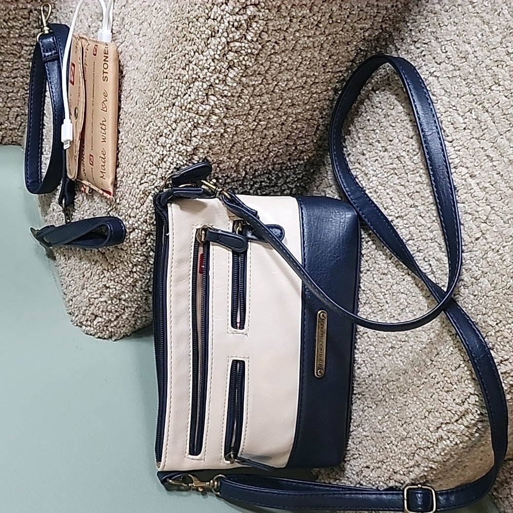 Navy and cream leather purse. 22” strap; 6” high; 9” wide. Excellent condition